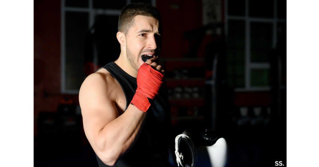 Boxer putting in mouthguard