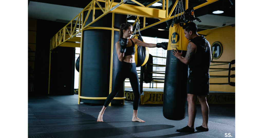 Woman using boxing bag